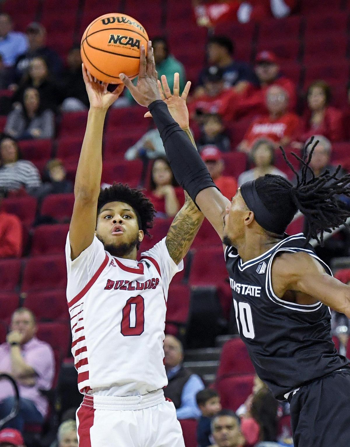 Fresno State’s Donavan Yap has his three-point attempt blocked by Utah State’s Dan Akin during their Mountain West Conference game at the Save Mart Center in Fresno on Saturday, Jan. 28, 2023.