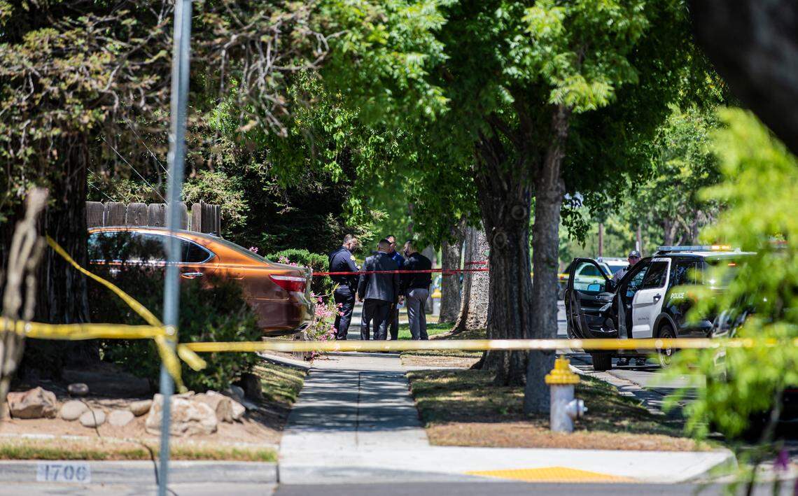 Detectives investigate a scene after an officer shot an armed suspect in central Fresno neighborhood on Thursday. May 19, 2022.