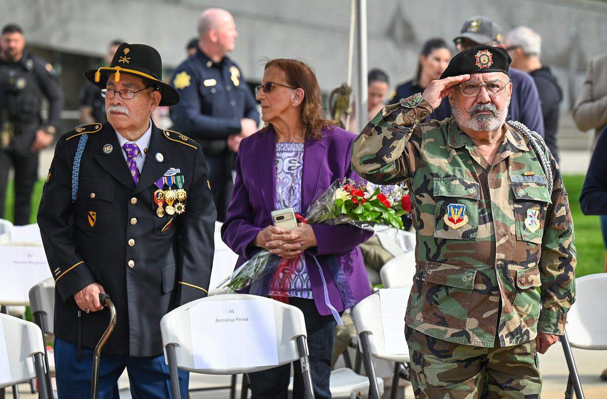 Veteran VIPs stand during the National Anthem before the start of the Central Valley Veterans Day Parade near Fresno City Hall in downtown Fresno on Tuesday, Nov. 11, 2025. 
