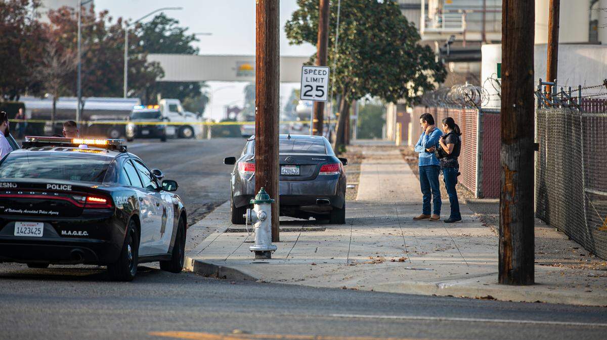 Detectives investigate a vehicle involved in a rolling gun battle at Ventura and E Streets on Monday, Nov. 22, 2021.