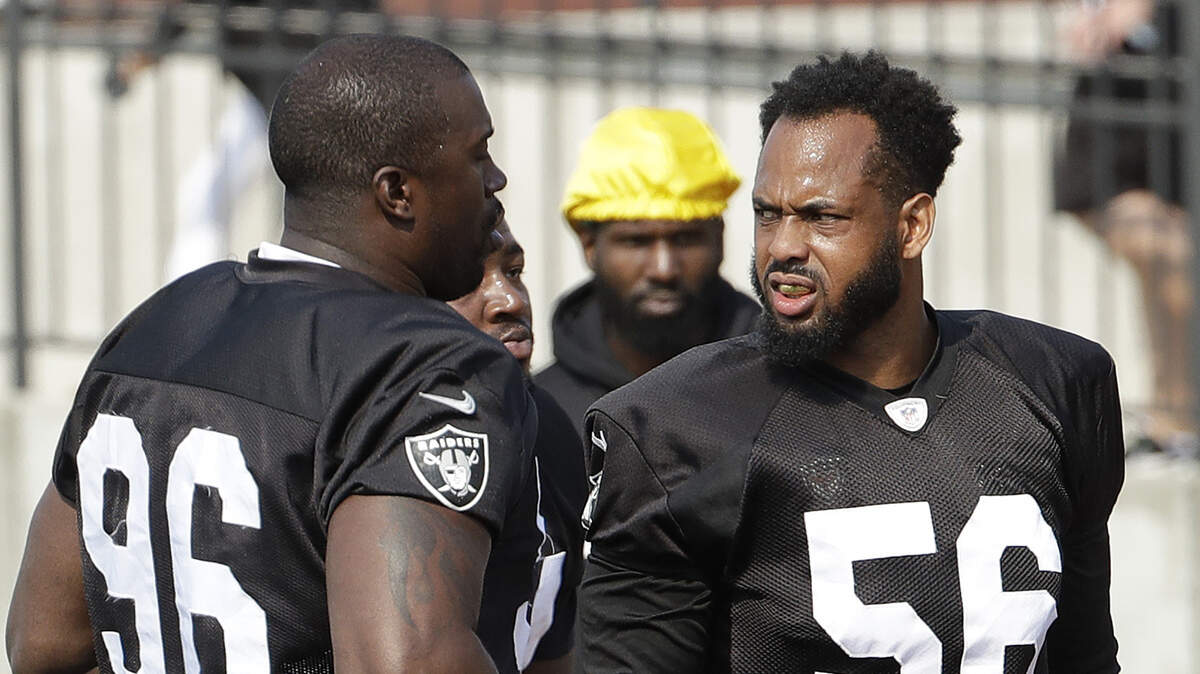 Linebacker Derrick Johnson (56), talking to Tank Carradine at an Oakland Raiders practice, is entering his 14th NFL season.