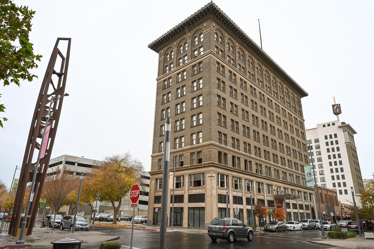 The historic Helm Building is seen between the Fulton Clock Tower in Mariposa Plaza and the Guarantee Savings Building in downtown Fresno in this Fresno Bee file photo from 2022. The Helm Building is Fresno’s first high-rise building but has not had residents in the upper floors since 1995. Developer Sevak Khatchadourian, who has successfully renovated the Pacific Southwest Building, is hoping to change that.