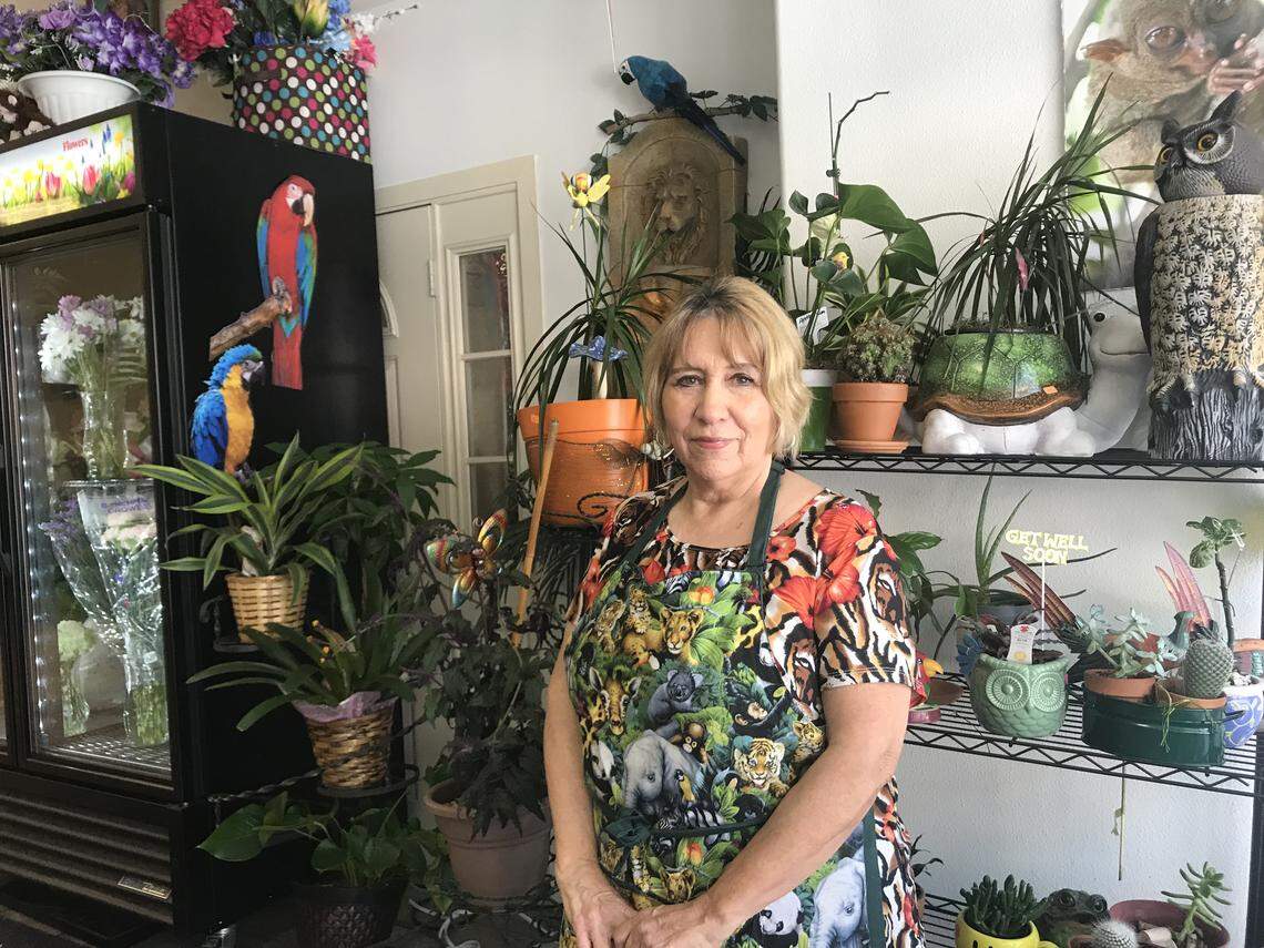 Patricia Valdes, owner of the Jungle Hut Floral Cafe, stands in her jungle-themed shop, which sells food and flowers.