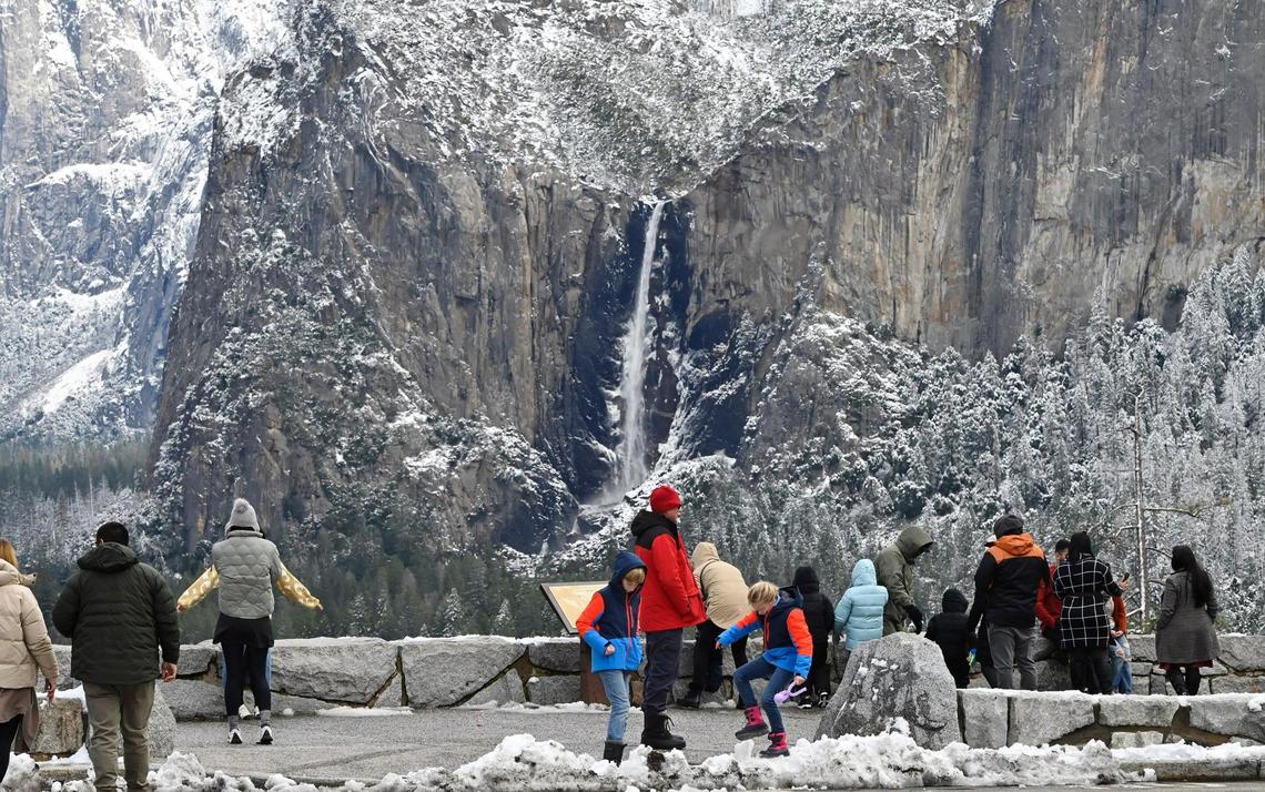 Bridalveil Fall is flowing while the cliffs around Yosemite Valley still show snow from its last snowfall as tourists stop at Tunnel View Friday, Feb 9, 2024 in Yosemite National Park. Public interest in the annual Firefall at Horsetail Fall has increased as the best viewing time approaches this month.