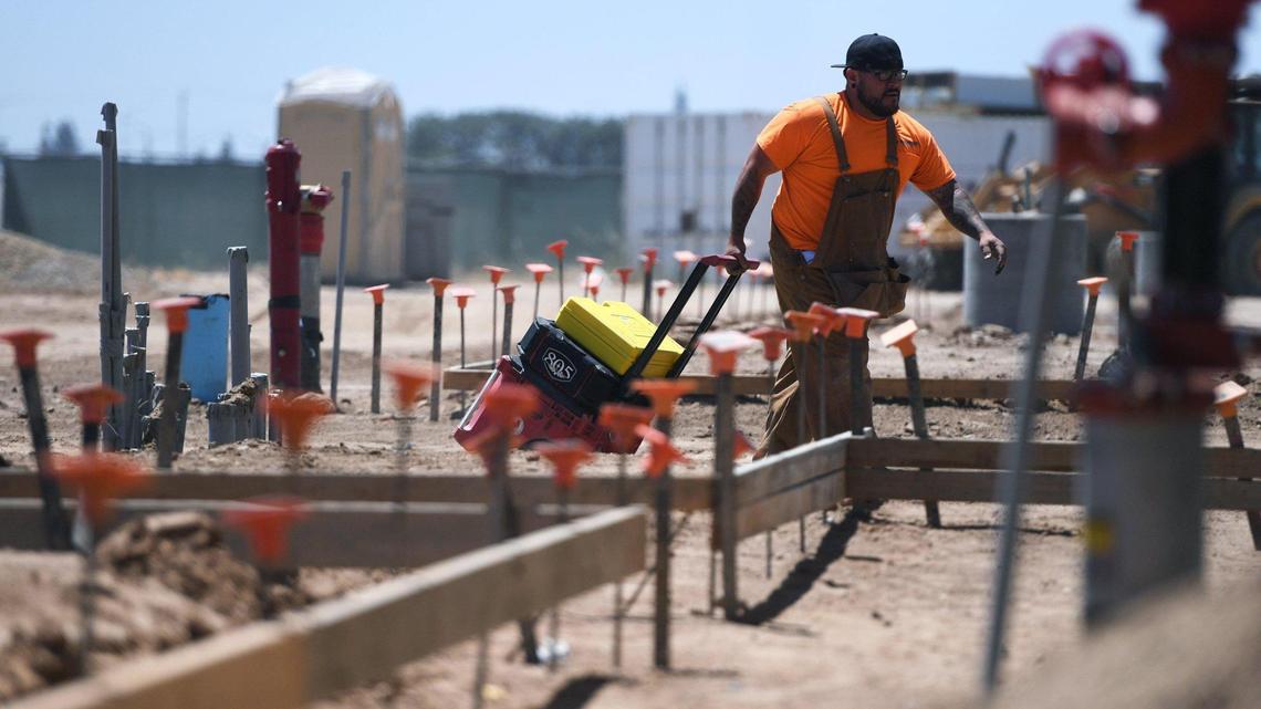 A worker moves tool cases at construction site in Fresno in this May 2022 file photo. More people were employed in Fresno County in May 2022 than in any other month since at least 1990, according to estimates released June 17, 2022, by the California Employment Development Department.