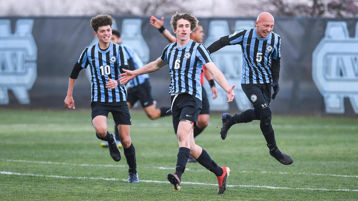 Clovis North’s Steven Mohr, center, celebrates a goal against Reedley with teammates Armaan Sahota, left, and Mihran Semerdzhyan during their match at Clovis North on Tuesday, Feb. 22, 2022.