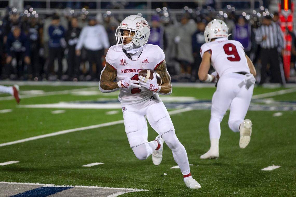 Fresno State’s Nikko Remigio (1) carries against Nevada during the first half of an NCAA college football game in Reno, Nev., Saturday, Nov. 19, 2022.