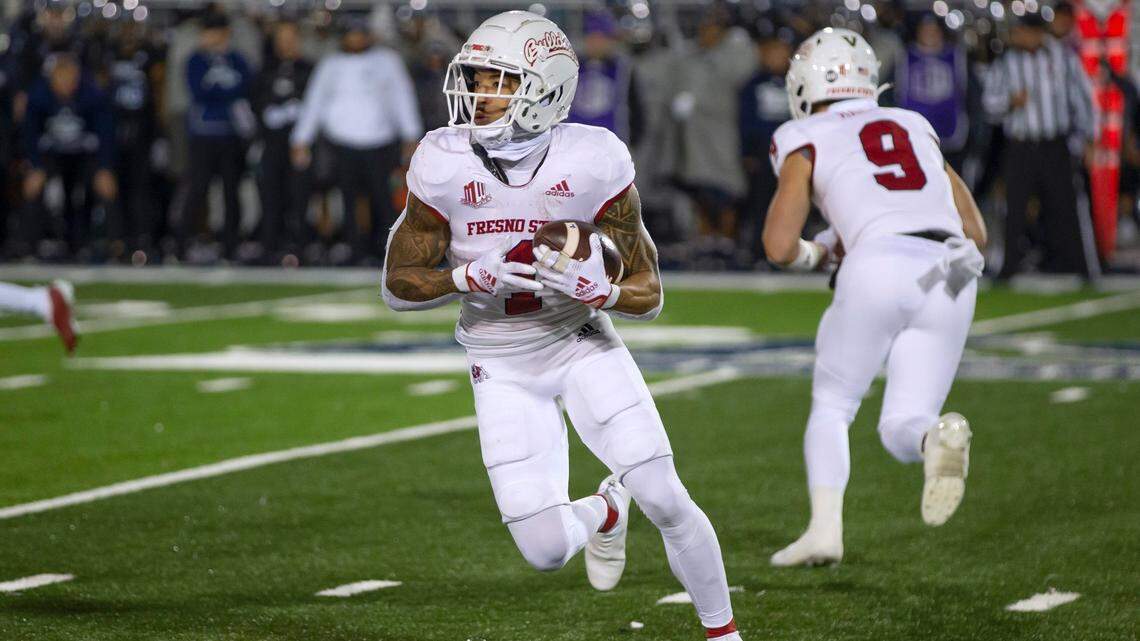 Fresno State’s Nikko Remigio (1) carries against Nevada during the first half of an NCAA college football game in Reno, Nev., Saturday, Nov. 19, 2022.