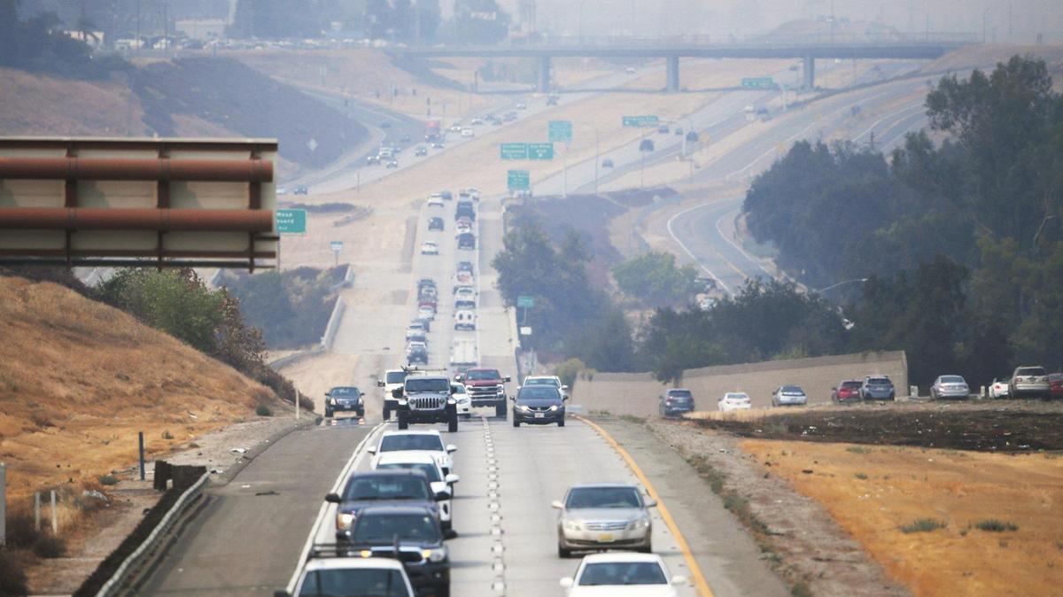 Traffic on northbound Highway 41 approaches town as smoke from wildfires hundreds of miles away blankets the Fresno area Thursday, Aug. 19, 2021, in Fresno.