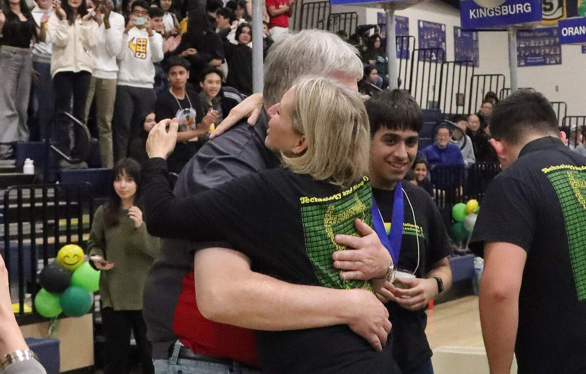 University High coach Sean Canfield and Hallmark Charter coach Angela Ballew share a hug after University was announced as the 2024 Fresno County Academic Decathlon champion, with Hallmark a close second.