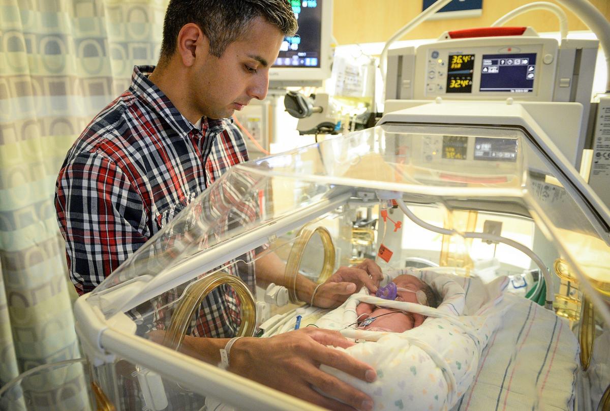 Elesandro Flores Jr. spends some time with his newborn daughter Quinn in the NICU at Community Regional Medical Center in Fresno on Tuesday, Oct. 30, 2018.