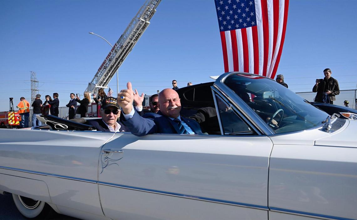 Fresno Mayor Jerry Dyer gives a thumbs up as he and others including former Fresno County Supervisor Phil Larson, seated behind Dyer, lead a parade over the Veterans Boulevard overpass after the ribbon-cutting ceremony for the opening of Veterans Boulevard Monday, Nov. 20, 2023 in Fresno.