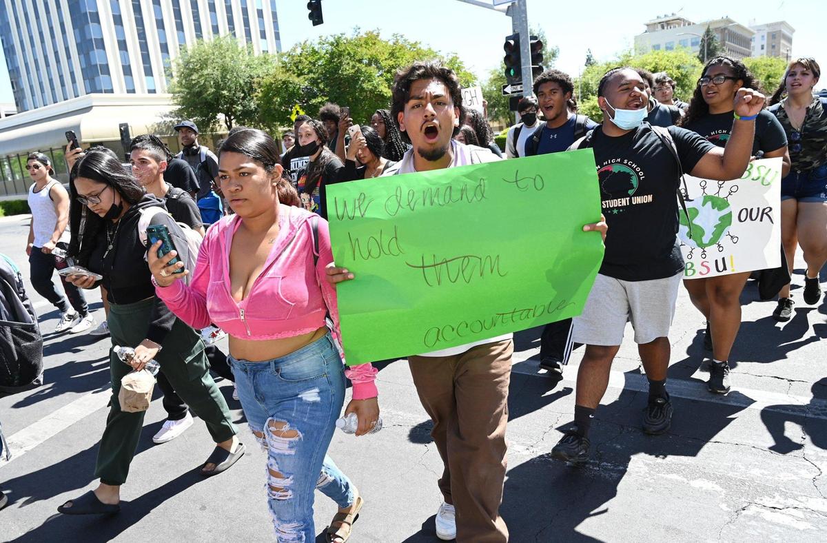 Hundreds of students cross M Street along Tulare Ave. after they marched from Edison High to Friday’s Fresno Unified School Board assembly addressing a racist photo posted to social media earlier in the week at Bullard High. Photographed Friday, May 6, 2022 in Fresno.