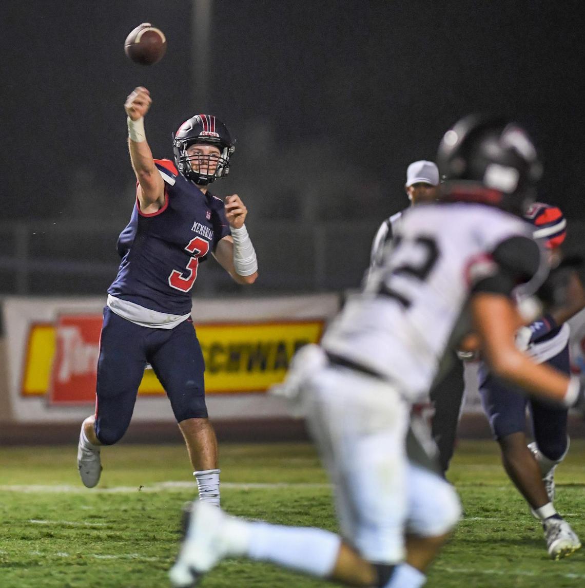 Memorial quarterback Mikey Bell throws against Hanford in the first half of their game at San Joaquin Memorial on Friday, Aug. 27, 2021. The game was later suspended due to poor air quality.