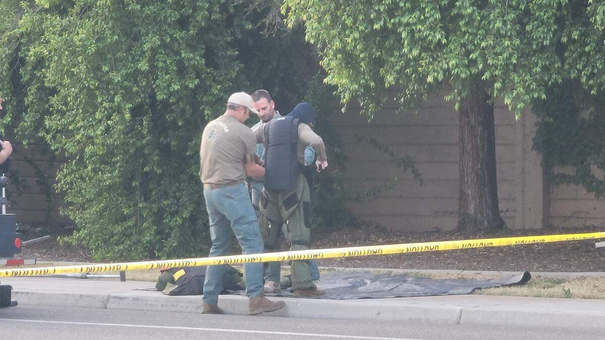 A member of the Clovis Police Bomb Squad gets ready to investigate a suspicious package on Willow Avenue on Monday evening, April 25.