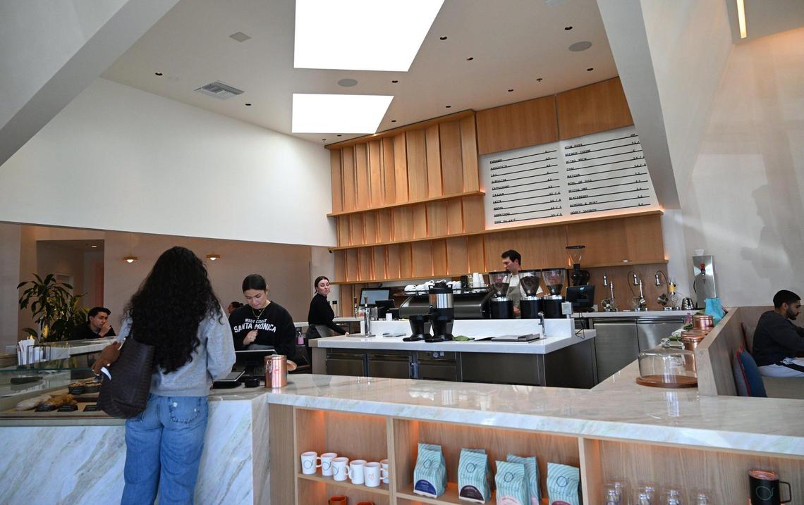 A customer places an order at Otherside Cafe, Brandon Smittcamp and his partners’ latest venture offering espresso drinks, food and desserts in northeast Fresno.