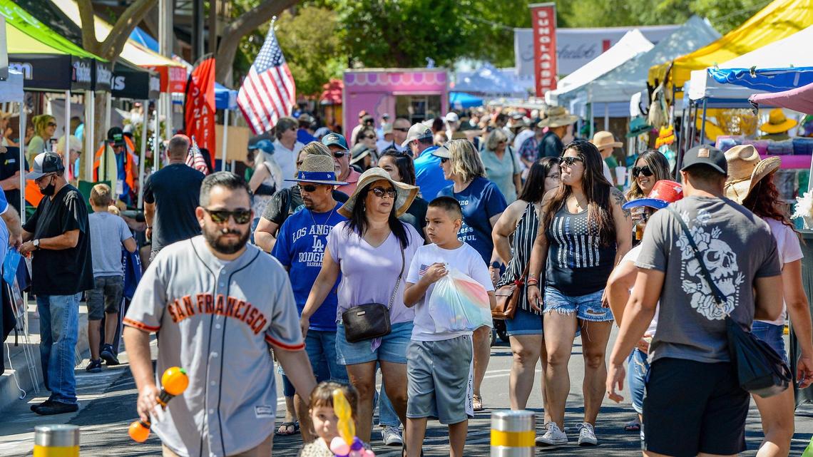 Crowds peruse vendor booths along Pollasky Avenue during Big Hat Days in Old Town Clovis on Saturday, June 12, 2021. After last year’s cancellation due to the pandemic, this year’s Chamber of Commerce-sponsored event was pushed back from April as businesses work toward a full reopening.