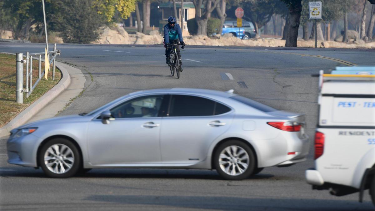 A cyclist navigates traffic at the Audubon Drive entrance to Woodward Park, Feb. 2, 2022.