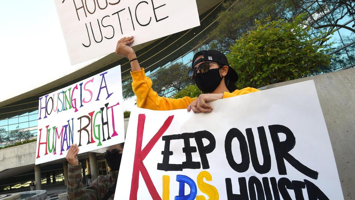 Demonstrators hold signs during a press conference at Fresno City Hall on April 8 held by the Right to Counsel coalition. The coalition is seeking help implementing legal support and protection for renters, who face evictions, unsafe living conditions and other problems.