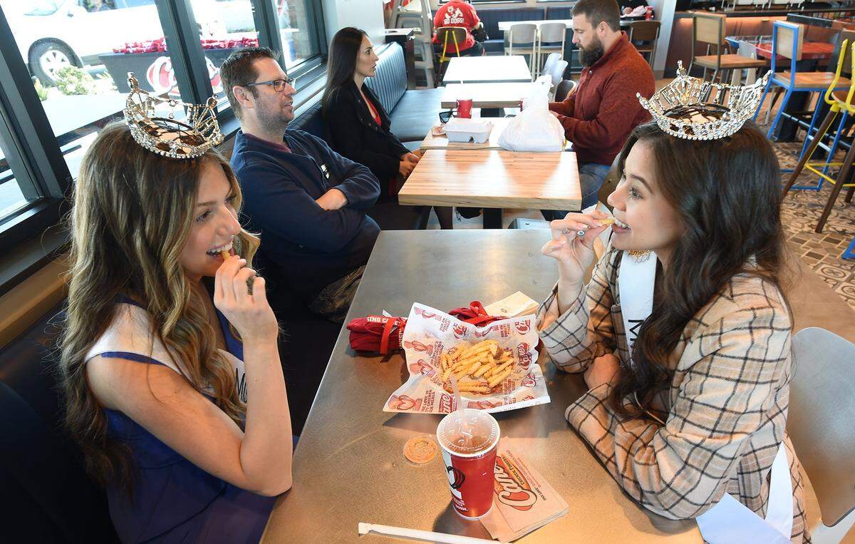 Royalty was on hand for the Tuesday morning ribbon-cutting opening of Raising Canes Chicken Fingers, with Miss Clovis Teen, Kayli Gibbons, left, and Miss Clovis Caleigh Alday, right, March 8, 2022.