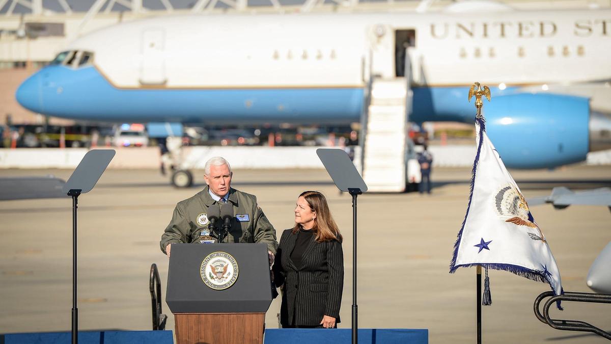 Air Force Two stands in the background as Vice President Mike Pence speaks before a group of airmen and women while Second Lady Karen Pence watches at Lemoore Naval Air Station on Saturday, Jan. 16, 2021.