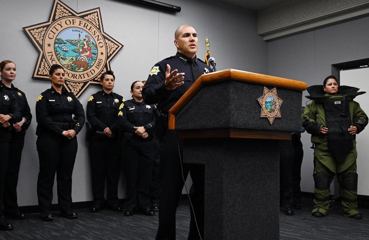 Fresno Chief of Police Paco Balderrama, center, with about 20 female officers and cadets in uniform behind him, announces a commitment to the 30x30 Pledge, a focus on improving the representation of women in the police force at a news conference Friday, March 25, 2022 in Fresno. The national initiative’s focus is to increase the numbers to 30 percent of women in new police recruits by 2030.