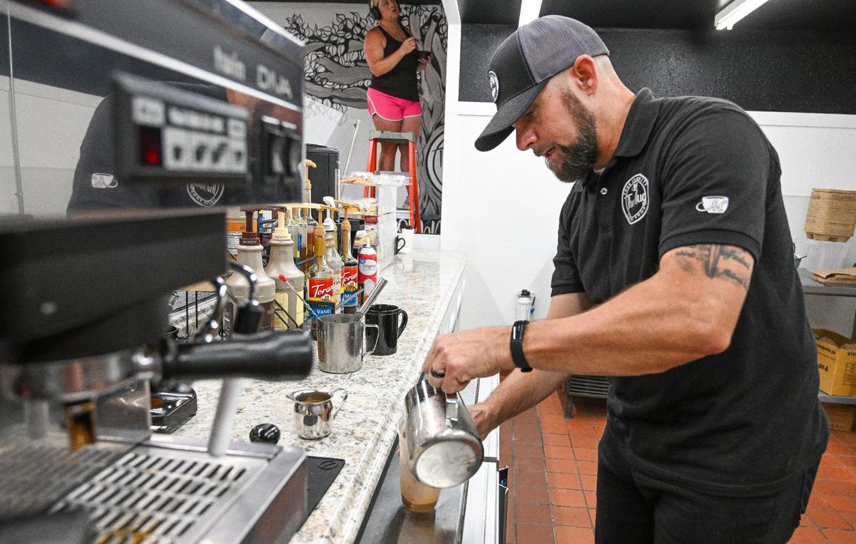 Michael Edgar of The Mug prepares a coffee drink inside the Peacock Artisan Eatery at the Peacock Market in Clovis in this Fresno Bee file photo from September.