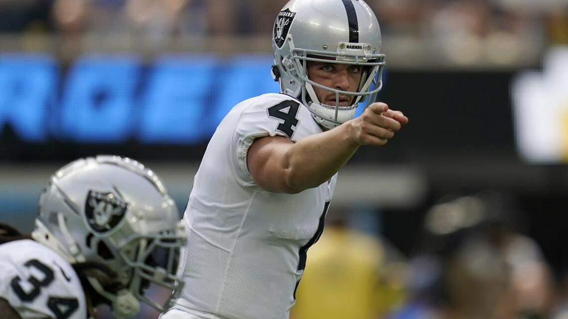 Las Vegas Raiders quarterback Derek Carr gestures toward teammates during the first half of an NFL game against the Los Angeles Chargers in Inglewood, Calif., Sunday, Sept. 11, 2022.