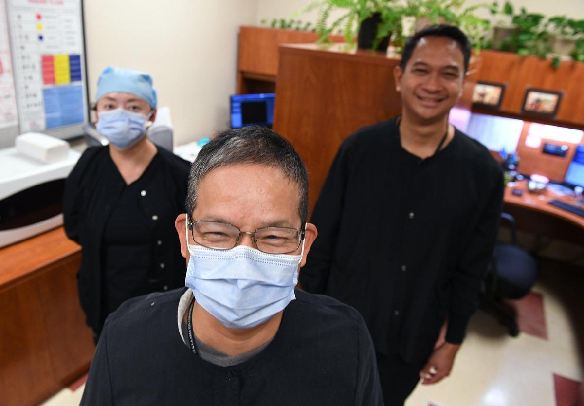 Dr. Li Lin, center, with Angela Tung to the left and Manuel Sanchez to the right, in the dental unit at Central Valley Indian Health Inc., shown Wednesday, April 21, 2021 in Clovis.