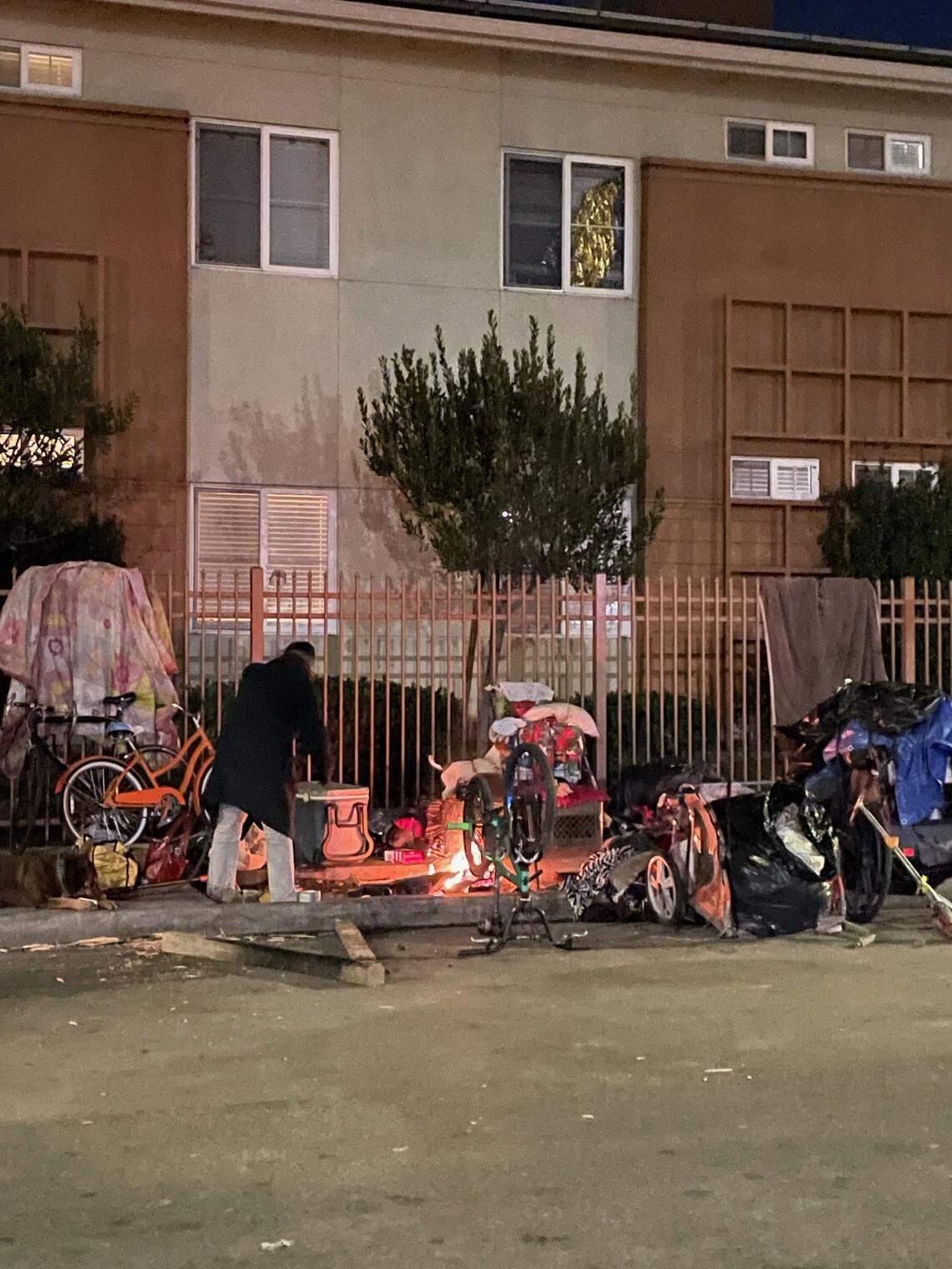 A warming fire in the midst of a camp on Santa Clara Street.