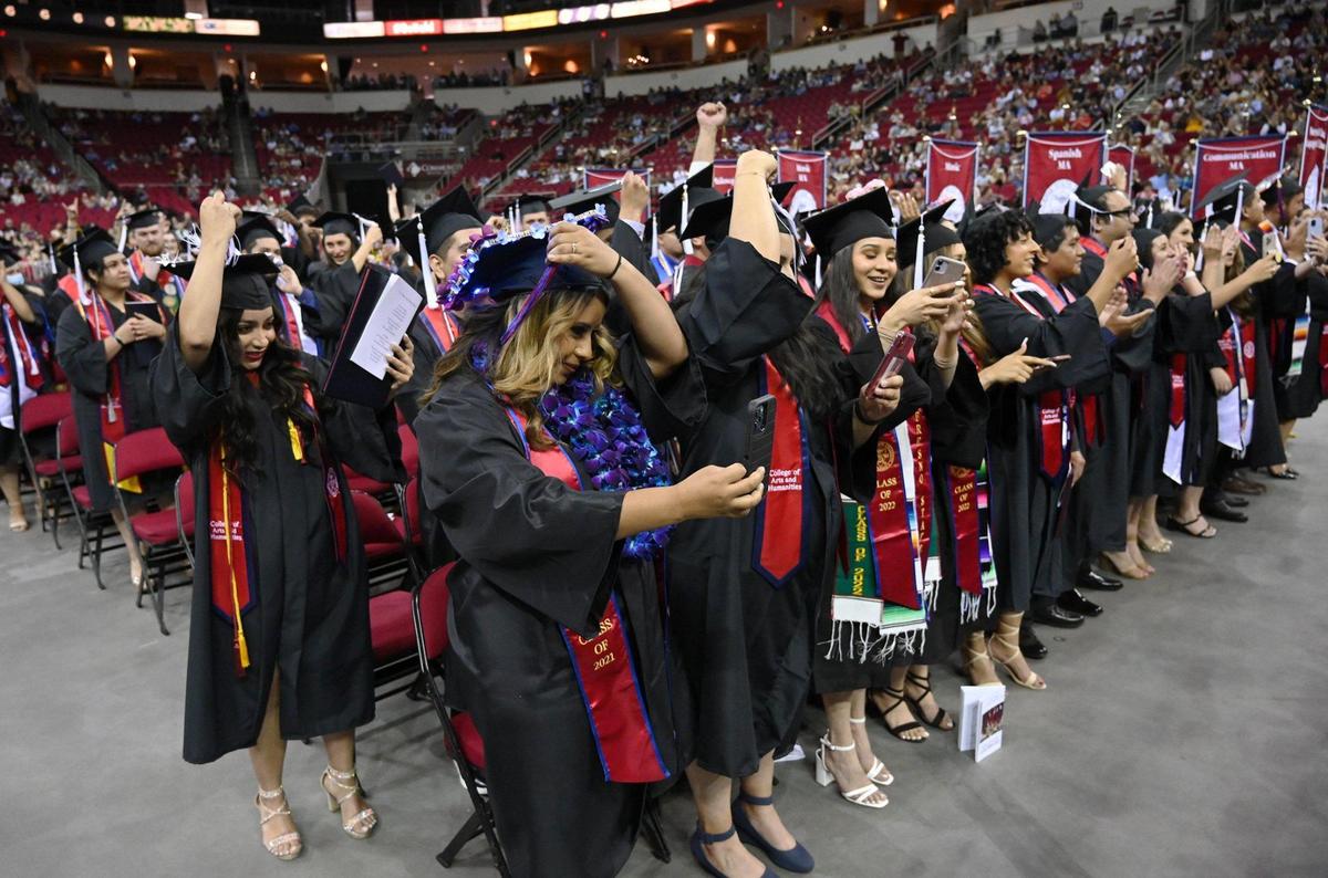 Graduates from Fresno State’s College of Arts and Humanities commencement move their tassels to the opposite side neat the end of the ceremony Friday, May 20, 2022 in Fresno.