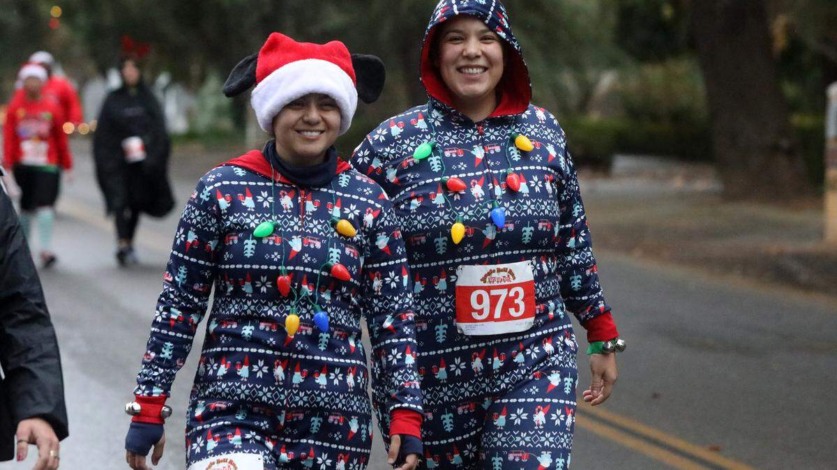 Keeping traditions or trying something new, either approach is good in the holidays. Here, Daisy Serrano of Fresno and Elizabeth Gama of Fresno joined 1,500 participants in the December 2022 Jingle Bell Run for Toys for Tots on Christmas Tree Lane in Fresno.,