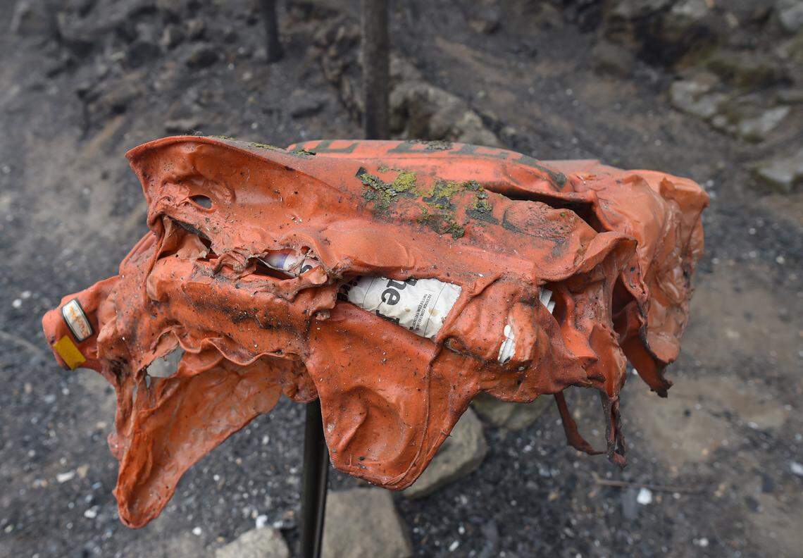 A melted newspaper box stands in a burned area of Meadow Lakes on Saturday Sept. 12, 2020