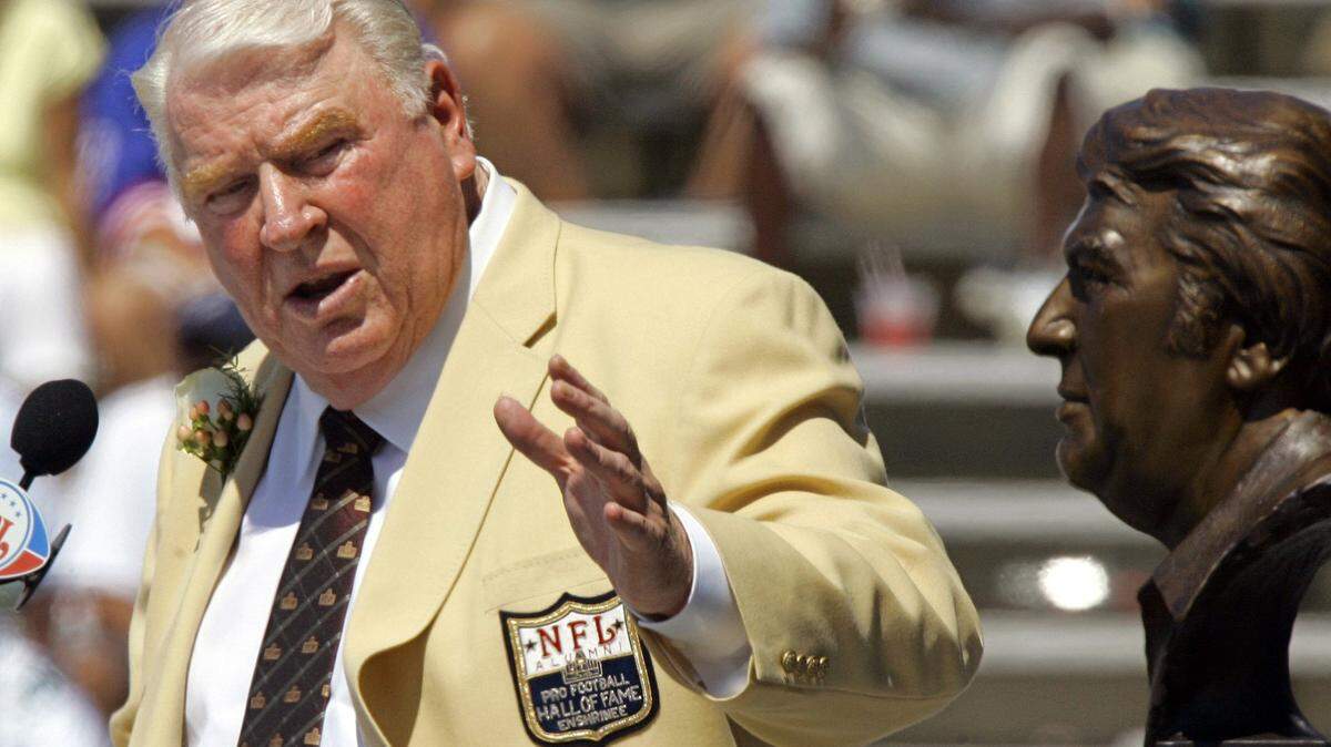 FILE - Former Oakland Raiders coach John Madden gestures toward a bust of himself during his enshrinement into the Pro Football Hall of Fame in Canton, Ohio, Aug. 5, 2006. John Madden, the Hall of Fame coach turned broadcaster whose exuberant calls combined with simple explanations provided a weekly soundtrack to NFL games for three decades, died Tuesday, Dec. 28, 2021, the NFL said. He was 85.