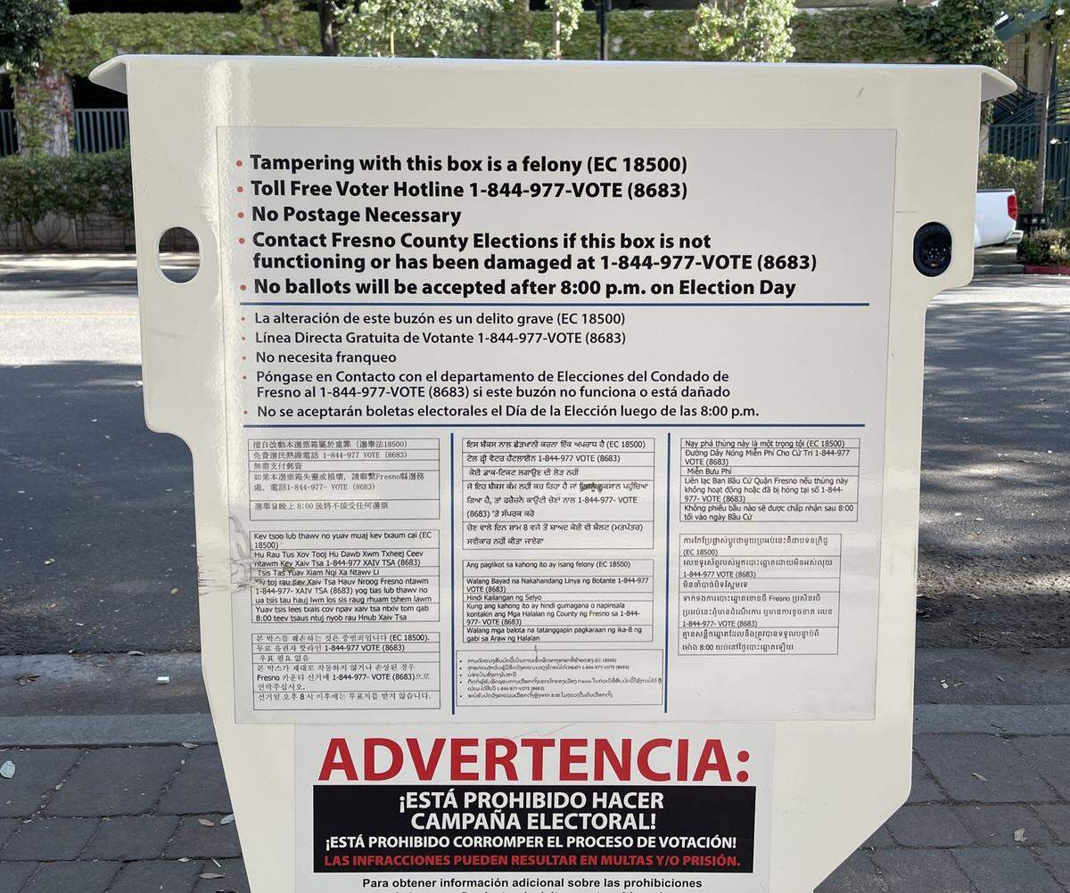 The back side of a Fresno County ballot drop-off box includes warnings in multiple languages against tampering with the box as well as ways to contact the county’s Elections Division if a box is damaged or malfunctioning.