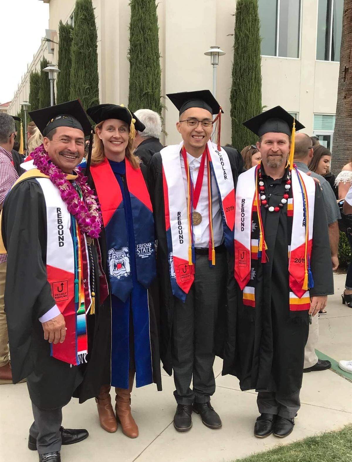 Emma Hughes, second from left, poses with Project Rebound graduates Arnold Trevino, Khoi Quach and Aaron Greene after Fresno State’s 2019 commencement ceremony.