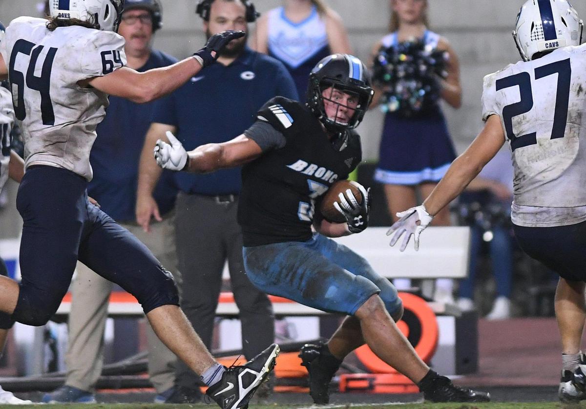 Clovis North running back McKay Madsen, center, cuts back between Central Valley Christian’s defense in second half action Friday, Sept. 9, 2022 in Clovis. CVC won the nonleague game 23-9.