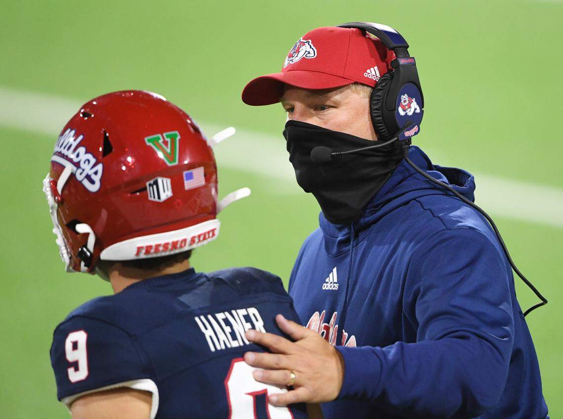 Fresno State head coach Kalen DeBoer instructs quarterback Jake Haener during their game against Colorado State at Bulldog Stadium on Thursday, Oct. 29, 2020.