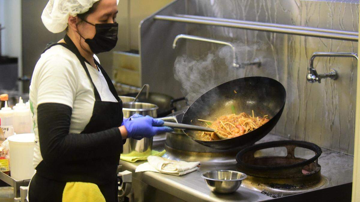 Owner Manila Malaythong prepares pad thai at The Coconut Cafe in Merced, CA.