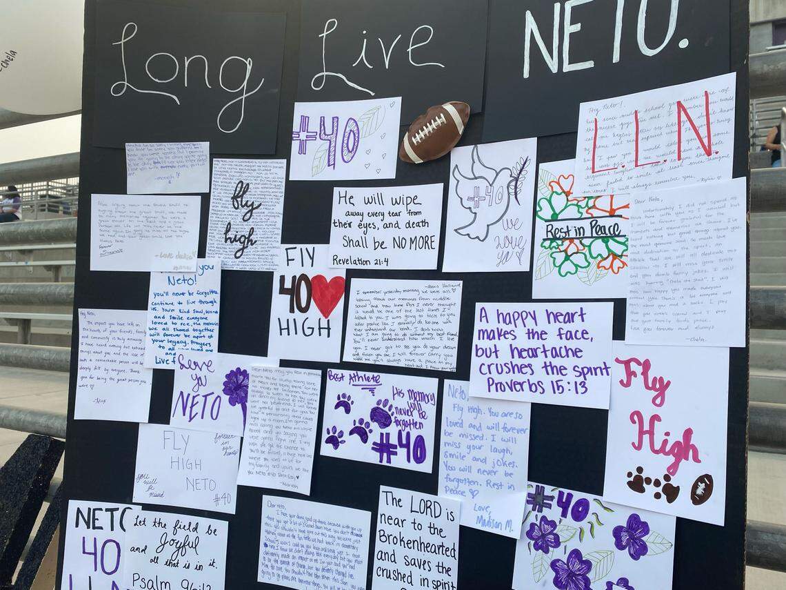 Teammates and friends write on an index card to remember Washington Union junior Lorenzo Garin, 16, who was killed in a car crash on Thursday, Aug. 27, 2021.