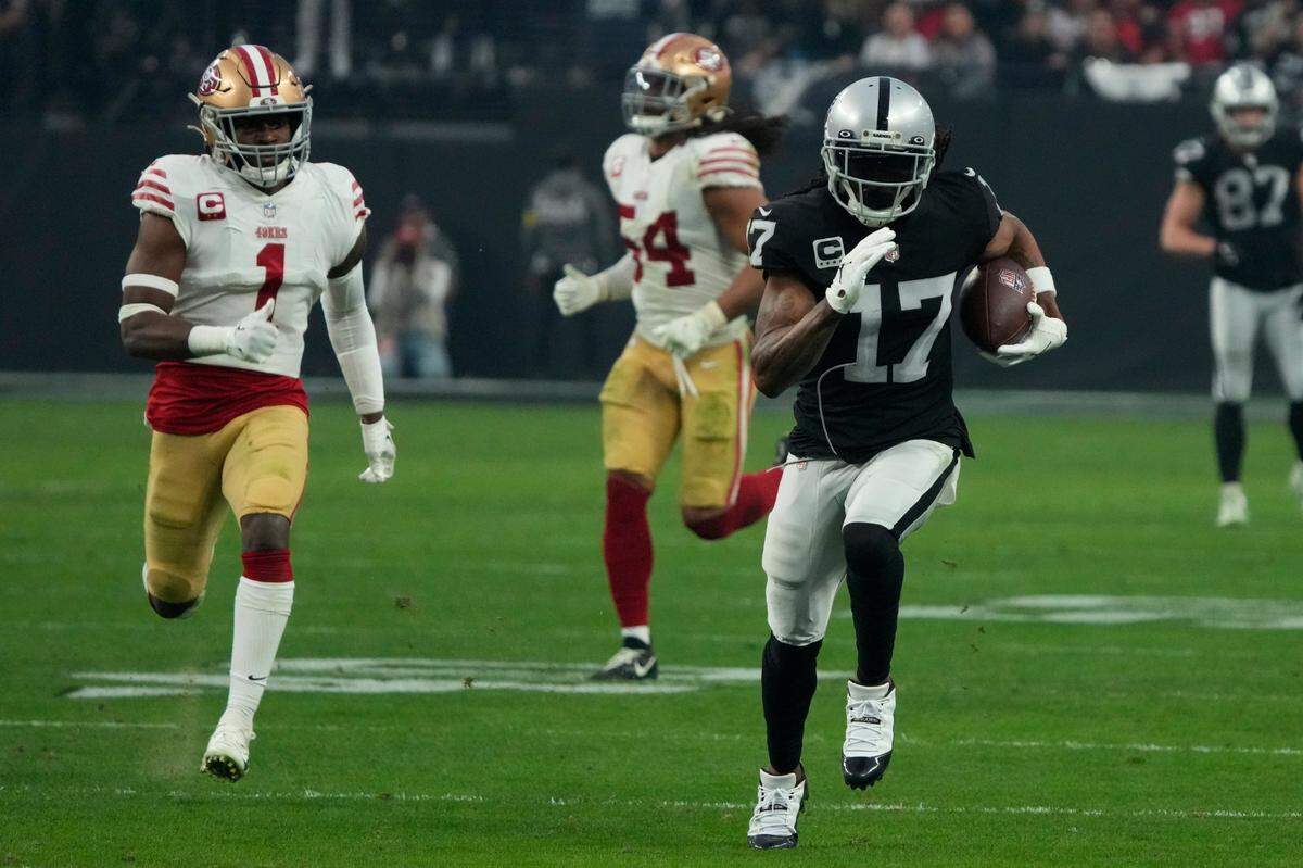 Las Vegas Raiders wide receiver Davante Adams scores a touchdown against the San Francisco 49ers during the first half of an NFL game, Sunday, Jan. 1, 2023, in Las Vegas.