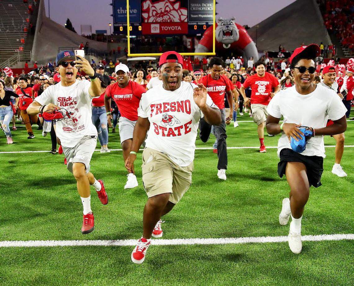 Fresno State wideout Jordan Brown, left, sprints across the field at Bulldog Stadium when a freshman taking part in a Run to Victory promotion. Brown was on the team one year later, through an open tryout for students.