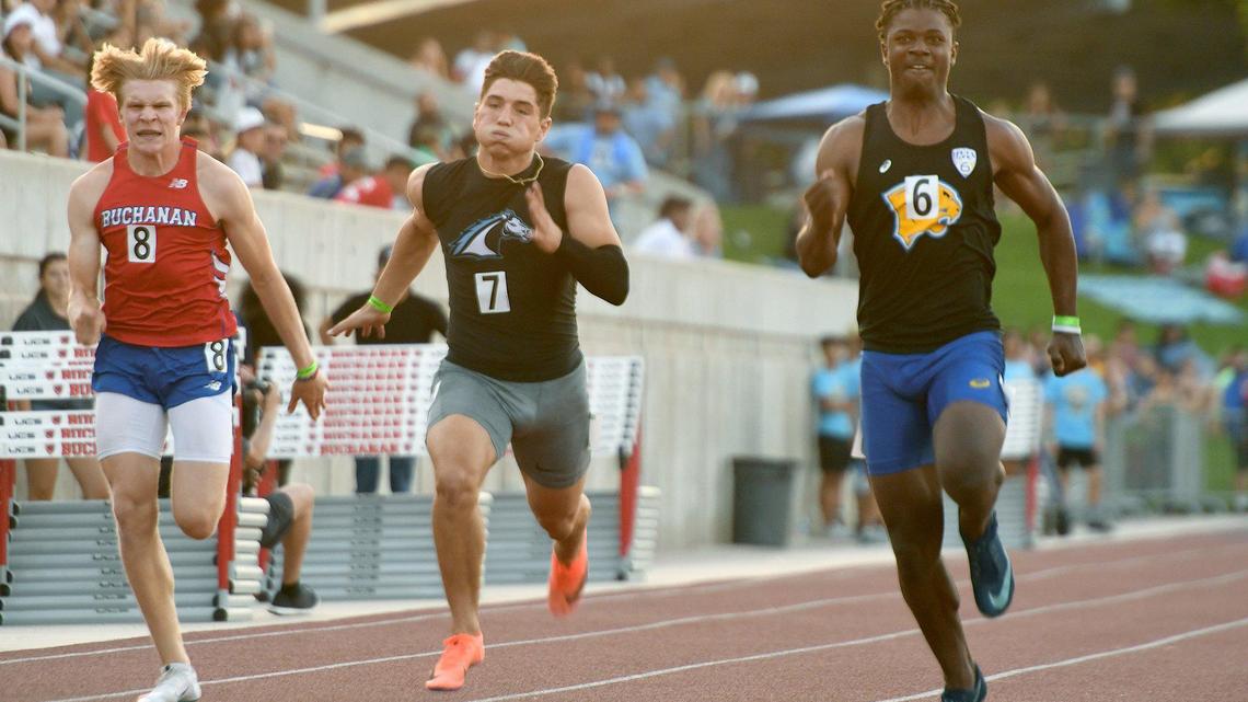Clovis High’s Nate Johnson, right, turns on the heat to win the 100 meters race ahead of Buchanan’s Garrett Fox, left, and Clovis North’s Jake Parnagian during the CIF Central Section Masters Track and Field 2021 Championships at Buchanan High, Saturday June 19, 2021.