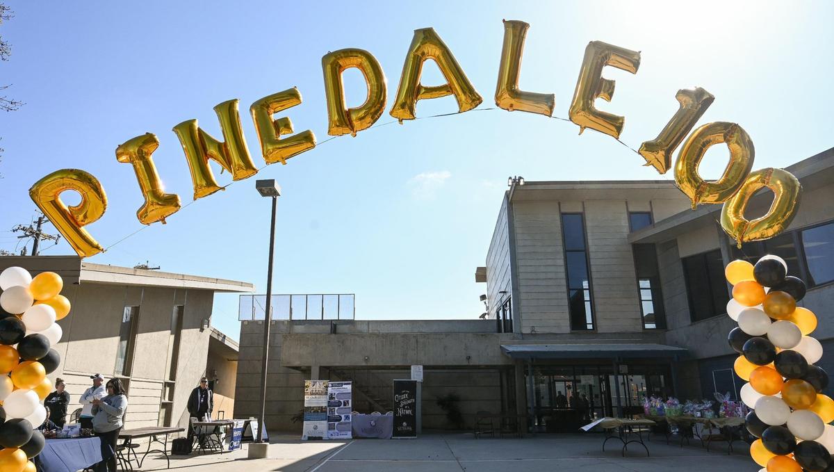 A ballon archway flutters in the wind outside the Pinedale Community Center during Pinedale’s centennial celebration and parade on Saturday, March 25, 2023. The community in north Fresno is celebrating the 100th anniversary of its establishment.