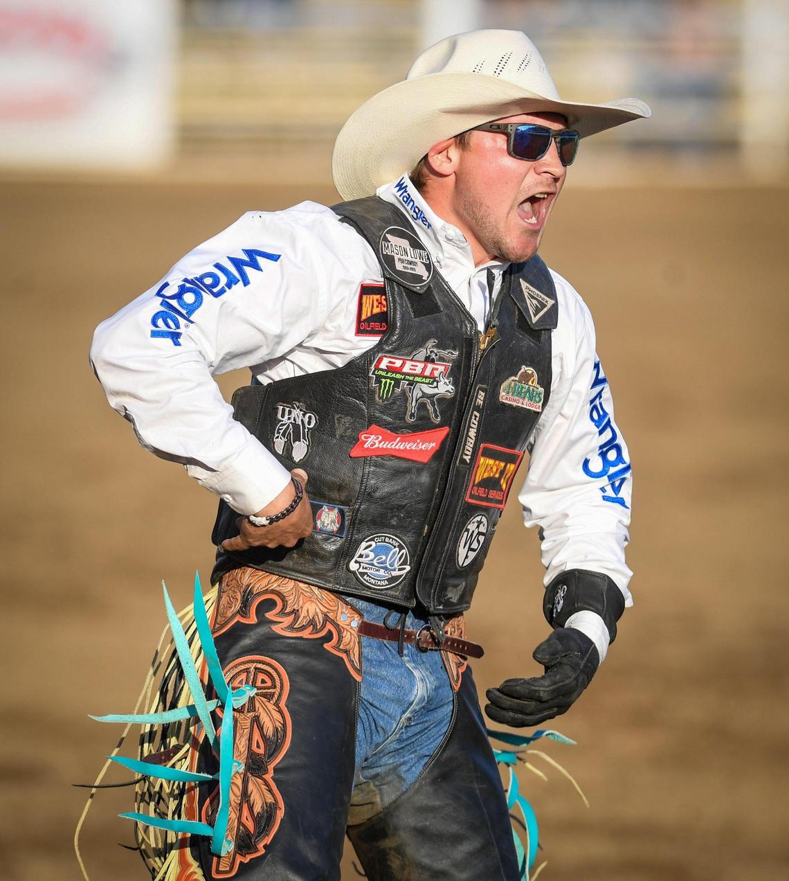 Pro bull rider Dakota Louis celebrates his 80.00 point ride on bull Cold Blood during the PBR event on the first night of the Clovis Rodeo at the Clovis Rodeo Grounds on Wednesday, April 21, 2021.