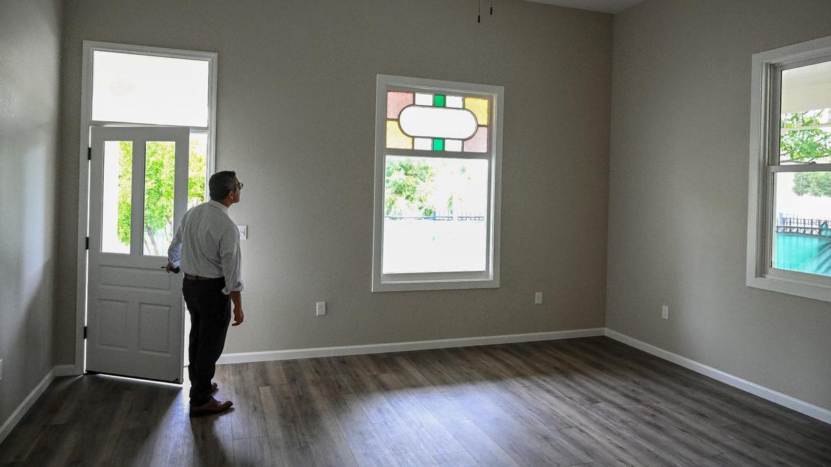 Fresno City Councilmember Miguel Arias takes a look inside on of the renovated historic Armenian homes that now sits at M and Santa Clara streets in downtown Fresno and will be used as affordable housing.