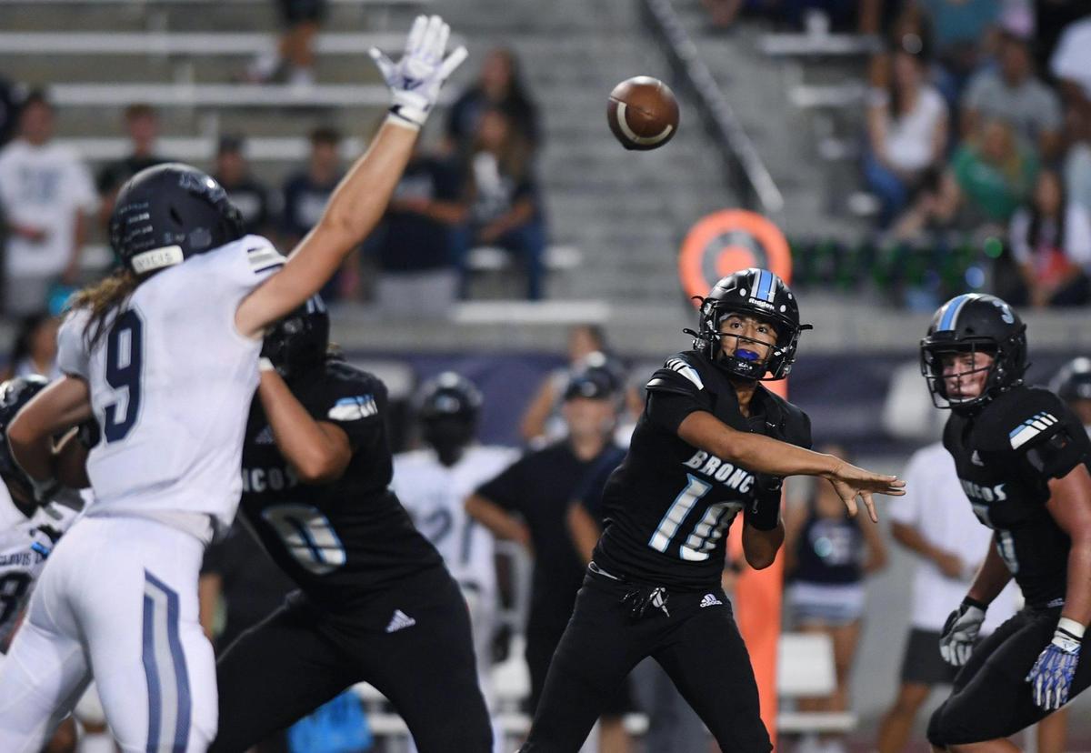 Clovis East’s Rocky Koontz, left, tries to block a pass from Clovis North quarterback Mario Cosma, center, Friday, Sept. 30, 2022 in Clovis.