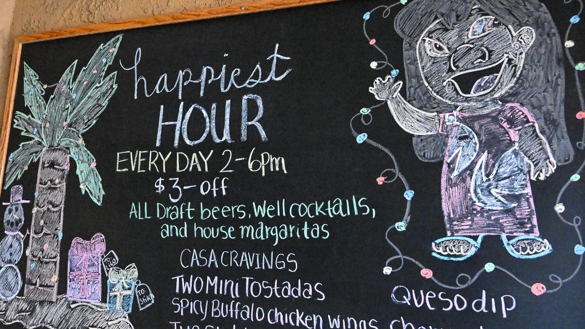 A sign with happy hour specials still hangs on the wall outside Casa Corona on Bullard and West in Fresno, which is now closed permanently. Restaurant owners say they will be focusing on their other location on Cedar and Herndon.