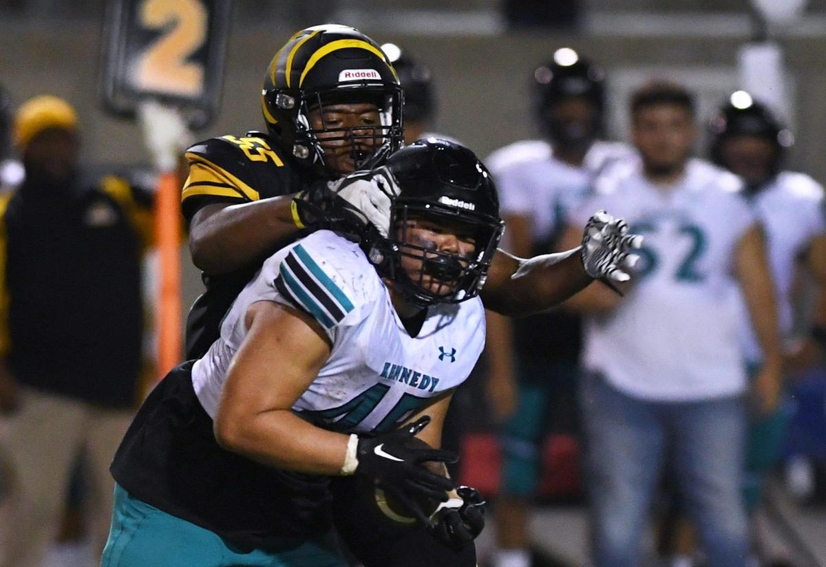 Edison’s Nick Ball, background, tackles Kennedy’s running back Jaikel De Leon, foreground, Friday, Aug. 19, 2022 in Fresno. Edison won 20-13.