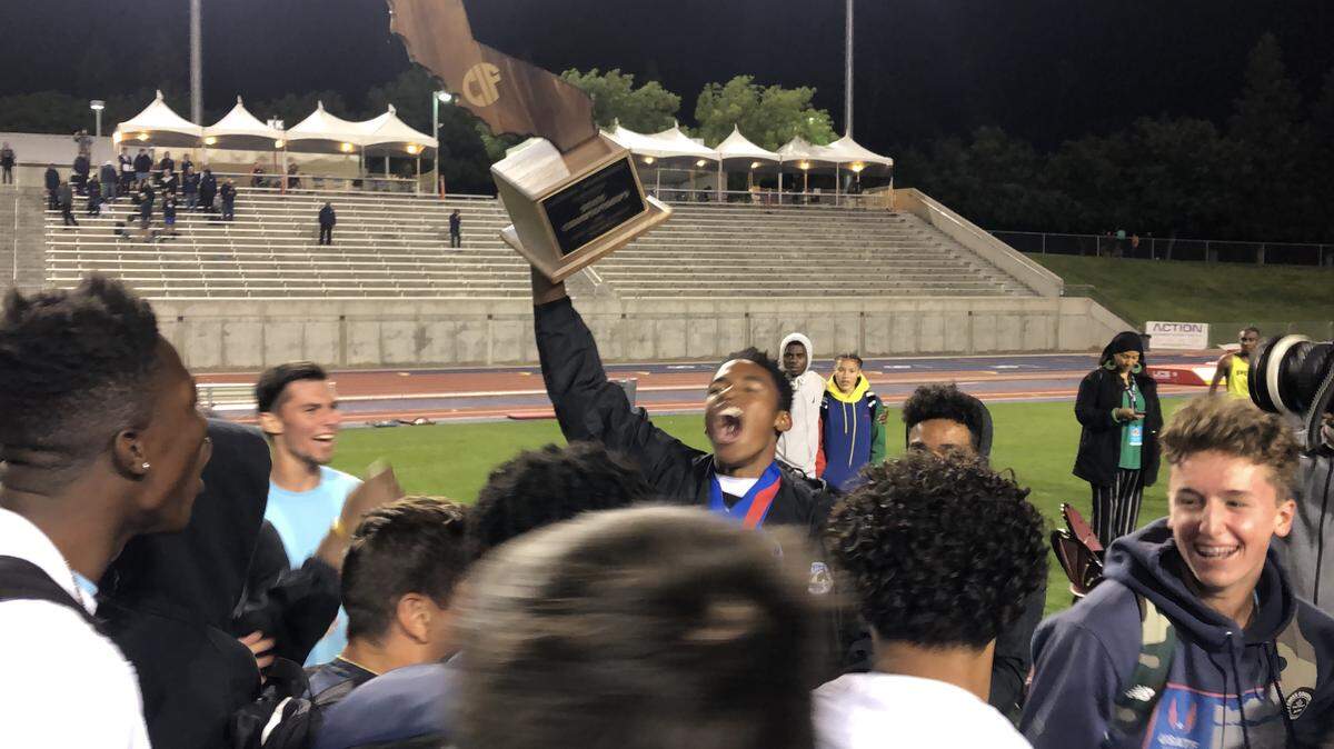 Caleb Foster, middle, celebrates with his team after Clovis North won the CIF track and field championships on Saturday, May 25, 2019.